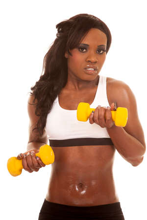 an African American working out with yellow weights, with a serious expression.の写真素材