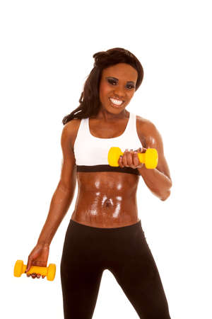 an African American in her fitness clothing holding on to her weights.の写真素材
