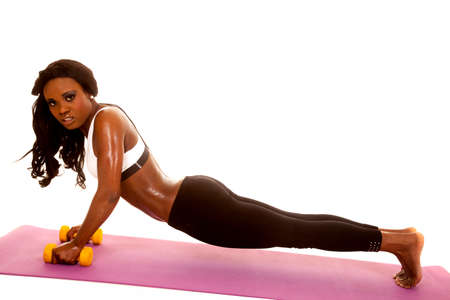 an African American doing push ups on her weighsの写真素材