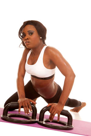 An African American doing some push ups, using push up bars.の写真素材