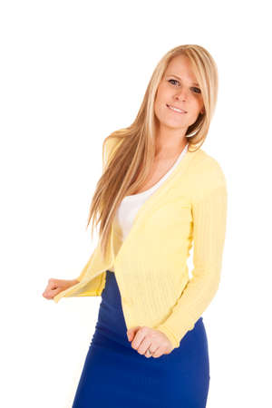 a woman with a smile standing in her yellow sweater and blue skirt.の写真素材