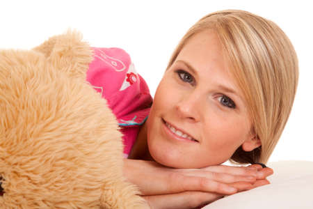 A close up of a woman next to her teddy bear.の写真素材