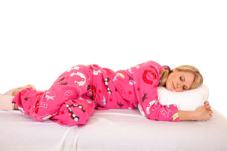 a woman laying on her bed asleep, on her pillow.の写真素材