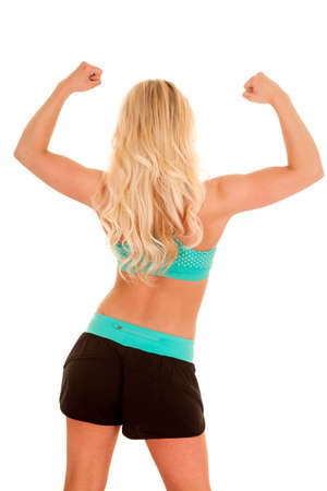 A blond woman showing off her back muscles flexing and working out.の写真素材