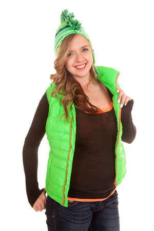A woman with a smile on her face wearing her lime green hat and vest.の写真素材