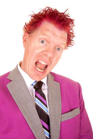 A man in his purple suit and with purple hair with a funny expression on his faceの写真素材