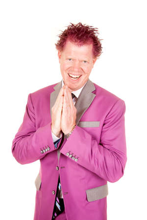 A man in his purple suit with a sneaky expression on his face.の写真素材