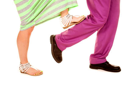 a woman taking a step on a man's calf while he is walking.