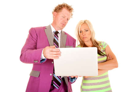 A man and woman looking at a laptop with a serious expression.の写真素材