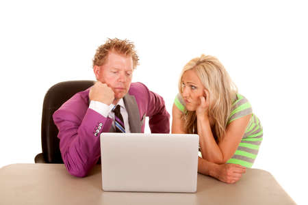 A business man and woman looking bored at the laptop.の写真素材