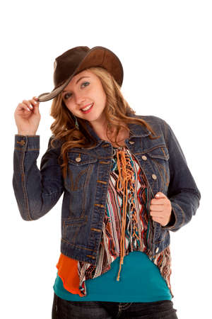 a woman in her cowgirl hat and jacket with a smile on her face.の写真素材