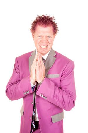 A man in his purple suit with a mischevious expression on his face.の写真素材