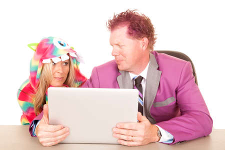 A business man holding his computer looking at a woman in her monster costume, with a smirk.の写真素材