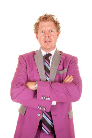 A man in a purple suit with a scared expression on his face standing with his arms folded.の写真素材
