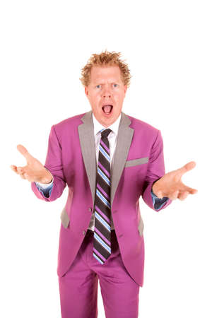 A man in a purple suit standing with his hands out screaming.の写真素材