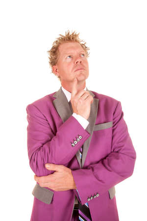 a man in a purple suit thinking about something.の写真素材