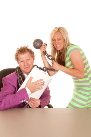 A man wrapped up in a woman's chain while holding on to his laptop.の写真素材
