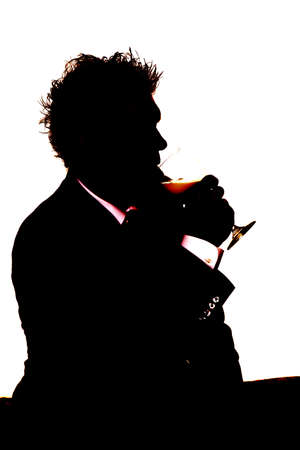 A silhouette of a man getting a drink from a glass.の写真素材