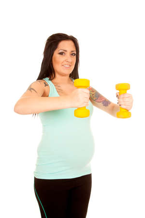 A pregnant woman trying to stay healthy by using weightsの写真素材