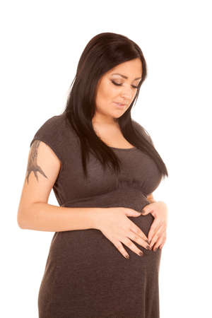 A pregnant woman with a heart on her pregnant bellyの写真素材