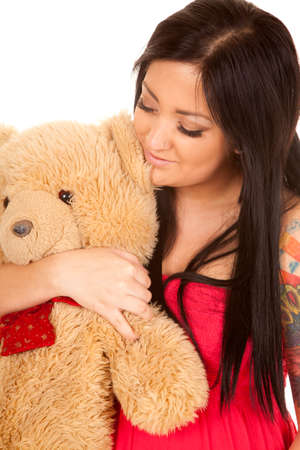 a pregnant woman holding her teddy bear close to her stomach.の写真素材
