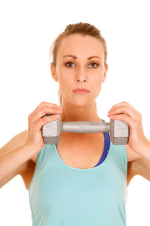 A woman with a serious expression on her face holding on to a weight.の写真素材