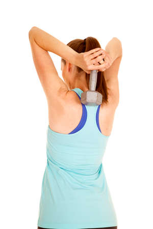 A woman working out with a weight, working her arms.の写真素材