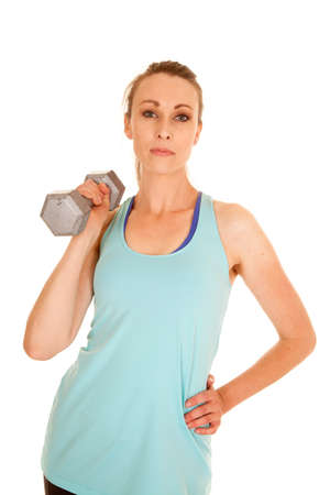 a woman working out with a weight with a serious expression on her face.の写真素材