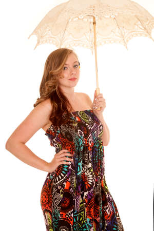 A woman in her colorful dress holding on to her umbrella.の写真素材