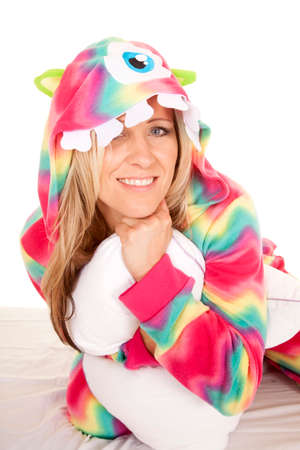a woman in her colorful pajamas with a monster hood on with a smileの写真素材