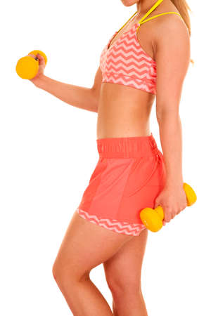 a side view of a woman in her fitness clothing working out with weights.の写真素材