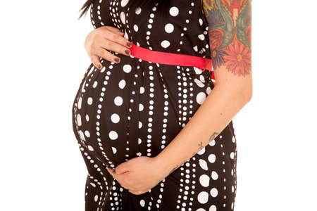 A close up of a woman in her polka dot dress with a tattoo on her arm.の写真素材
