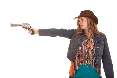 a woman pointing her gun to the side with a serious expression on her face.の写真素材