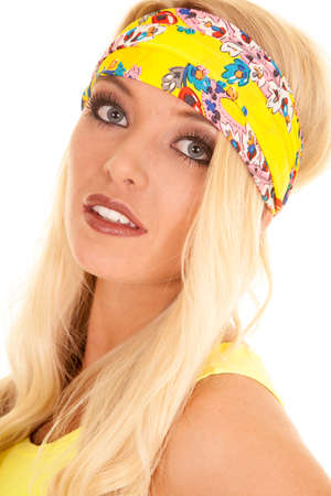 A close up of a woman in her yellow headband with a small smile.の写真素材