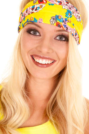 A woman in her yellow headband with a smile on her face.の写真素材