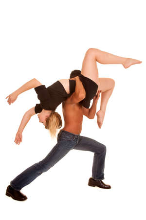 A man holding up his woman in a over the shoulder dance move.の写真素材