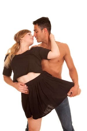 A woman and man dancing with her leg around her waist getting ready to kiss.の写真素材