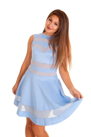 A woman in a blue formal dress holding out the bottom of it,の写真素材