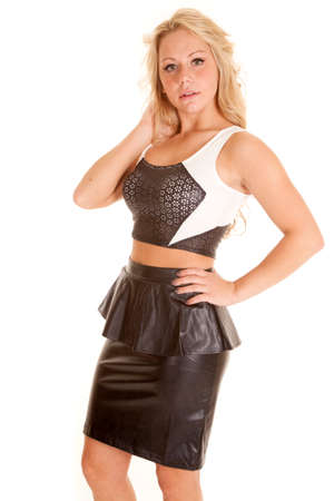 a woman in her black leather skirt and top with a serious expression on her face.の写真素材