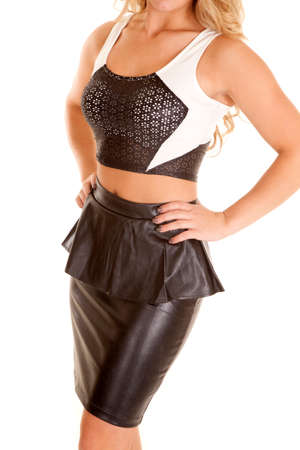 A woman in her stylish sports bra with a black leather skirt.の写真素材
