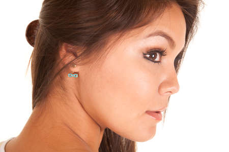 a woman  looking to the side, with an earring in her ear.の写真素材