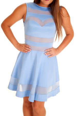 A woman in her blue sheer dress, with her hands on her hips.の写真素材