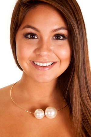 a woman with a smile on her lips, with a big pearl necklace around her neck.の写真素材