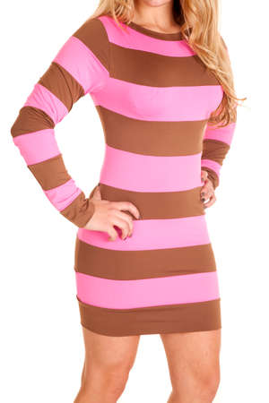 A close up of a woman in her brown and pink fitted dress.の写真素材