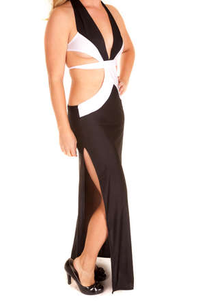 A woman in her black and white dress, showing off her leg in the slit.の写真素材