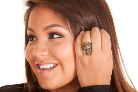 a close up of a woman's finger with a skull ring on her finger.の写真素材