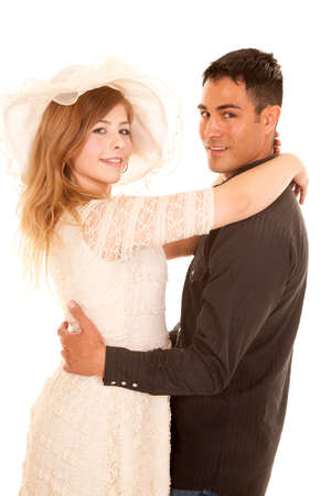 A couple with their arms around each other with smiles on their faces.の写真素材