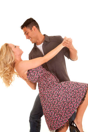 A man and woman dancing looking into each others eyes.の写真素材