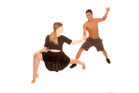 a man and woman doing dance moves she is in a lunge.の写真素材
