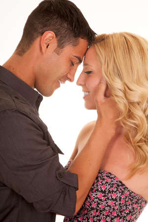 A close up of a man and woman with their heads together smiling.の写真素材